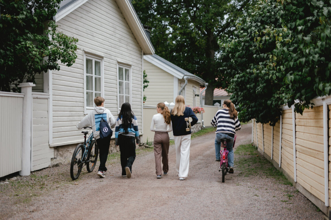 Ungdomar som promenerar längs en gata i gamla stan.